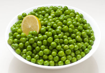 Close-up of green fruits in bowl on table