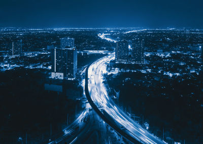 High angle view of illuminated buildings in city at night