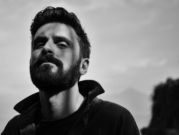 Close-up portrait of man against sky