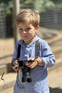 Portrait of cute girl playing with camera