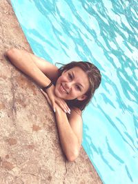 Portrait of smiling young woman in swimming pool