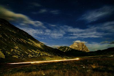 Scenic view of mountains against cloudy sky