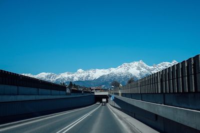 Highway leading towards snow covered mountains
