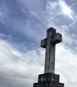 Low angle view of cross against sky