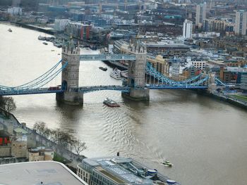 High angle view of tower bridge over thames river by buildings in city