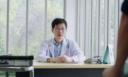  young asia doctor consult female patient and checkup in hospital , healtcare and assistance concept