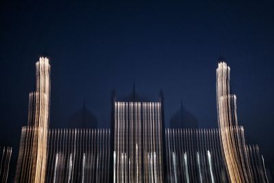 Low angle view of modern building against sky at night