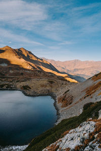 Scenic view of lake and mountains against sky