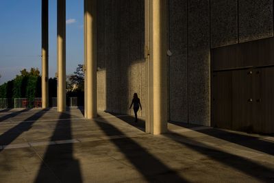 Man walking by building in city