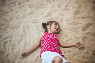 Happy girl on sand at beach