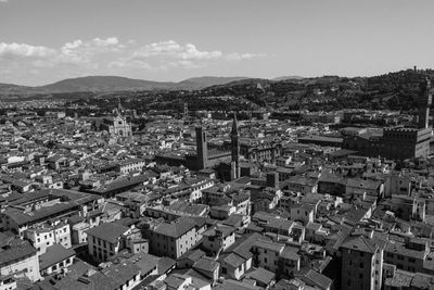 High angle view of houses in town against sky