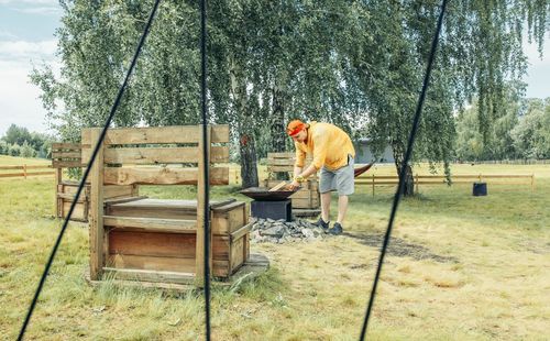 Rear view of man working at park