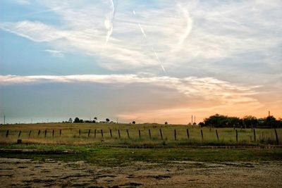 Scenic view of field against sky during sunset