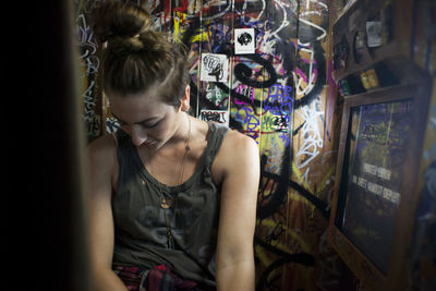 Young woman looking away at store