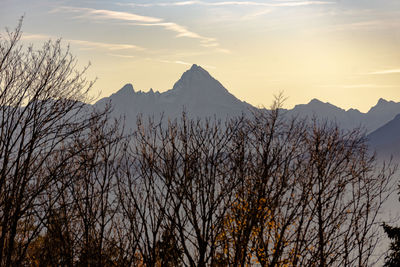 Scenic view of snowcapped mountains against sky during sunset