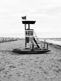 Lifeguard hut on beach against sky