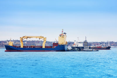 Ship sailing on sea against sky