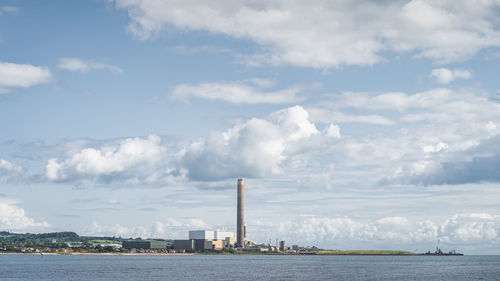 Large factory with tall chimney and industrial harbour on the northern ireland coast