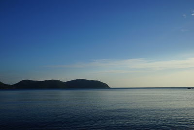 Scenic view of sea against blue sky