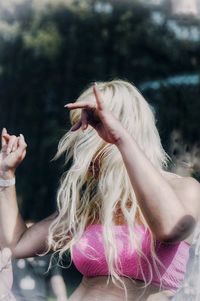 Woman dancing while standing outdoors