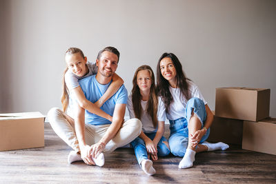 Portrait of happy family sitting at home