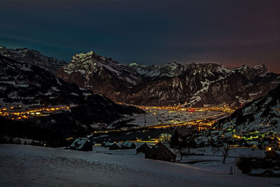 Scenic view of illuminated mountains against sky at night