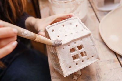 A master ceramist holds a clay product in his hands. making a ceramic candle holder from clay. 