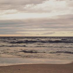 Scenic view of sea against cloudy sky