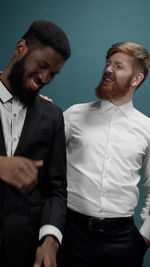 Smiling men against blue background