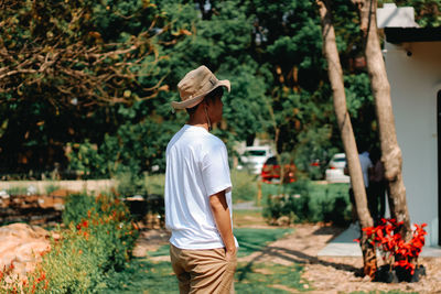 Rear view of man standing by plants