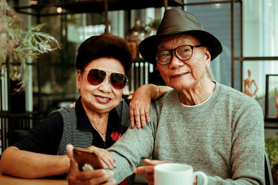 Portrait of happy friends sitting outdoors