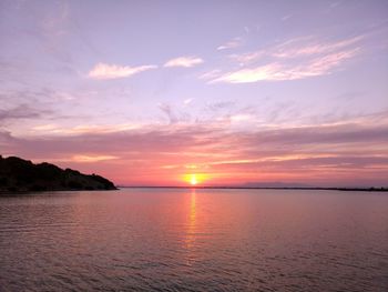 Scenic view of sea against romantic sky at sunset