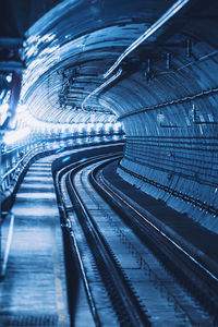 High angle view of railroad tracks in city at night