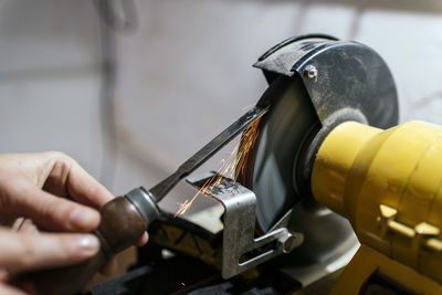 Close-up of man working on machine