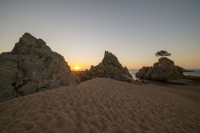 Scenic view of sea against clear sky during sunset