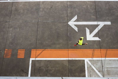 Young man running on parking level