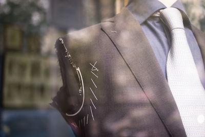 Close-up of suit in mannequin at store for sale