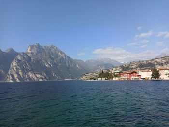 Scenic view of sea by buildings against sky