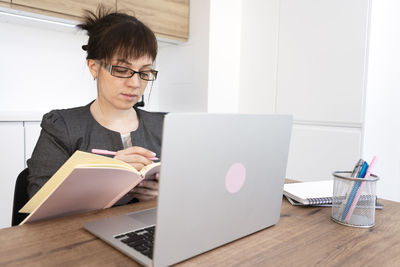 Young man using laptop at table