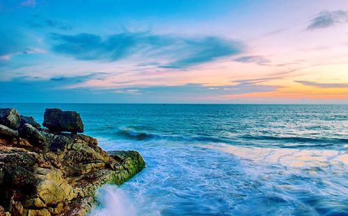 Scenic view of sea against cloudy sky