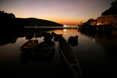 Boats in lake at sunset