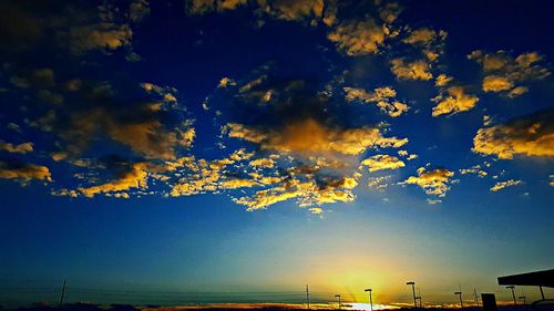 Low angle view of silhouette trees against sky at sunset