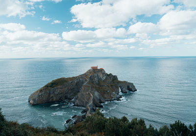 Scenic view of island in sea against sky