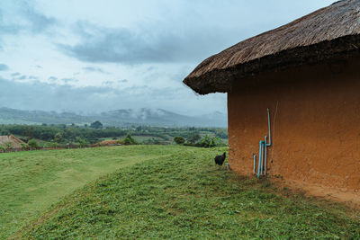 House on field against sky