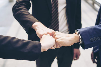 Midsection of couple holding hands