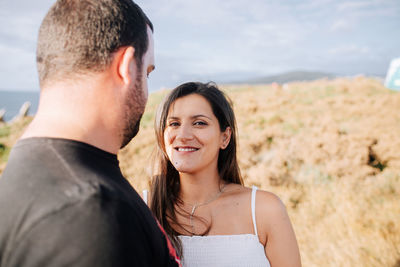 Portrait of smiling woman standing with man