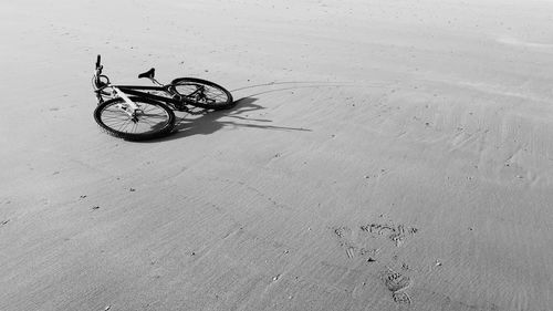 Close-up of bicycle on sand