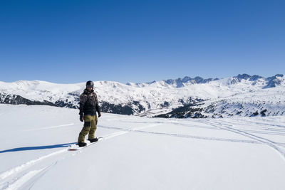 Man snowboarding off piste slope