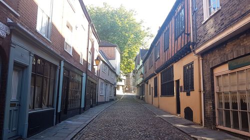 Street amidst buildings against sky