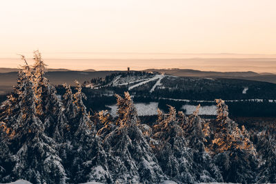 Scenic view of snow covered mountains against sky during sunset